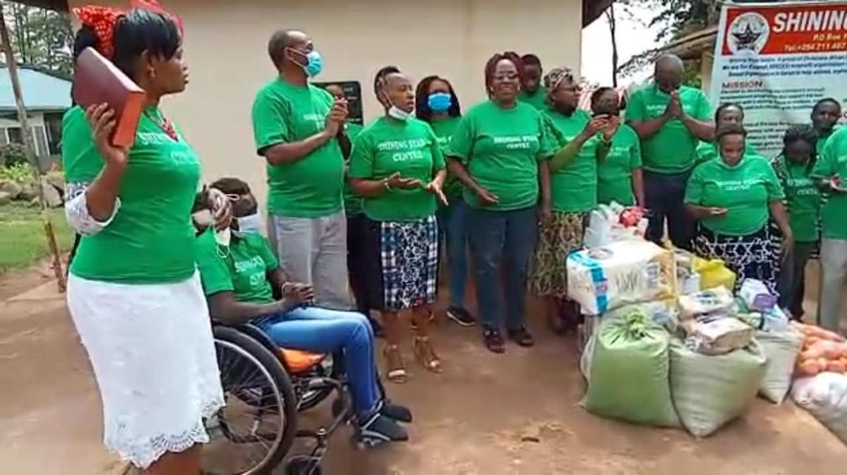 Shining Star Centre team praying over dignity and relief supplies before distribution