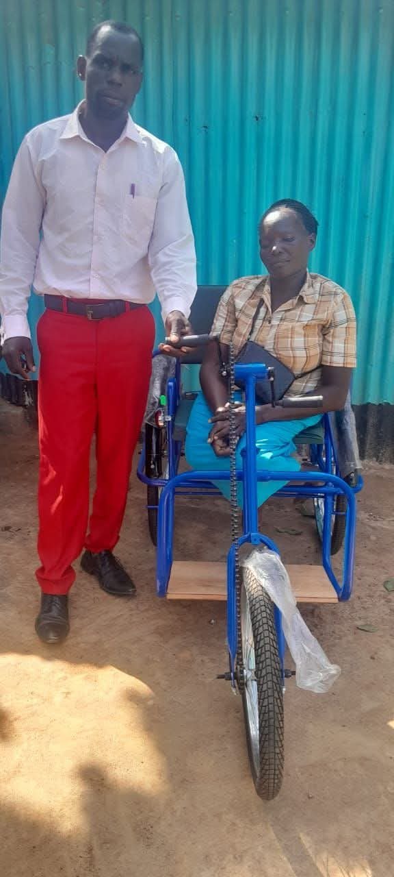 The same woman now mobile on a hand-powered tricycle provided by Shining Star Centre